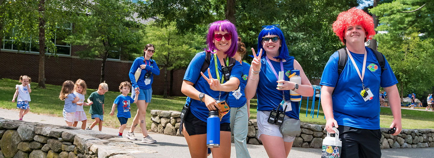 Group of campers cheering with their hands in the air